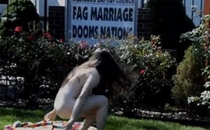 Underdressed woman at church. (Actually it's Laura Lush, bass-player with Get Shot, outside the Westborough Baptist Church.)